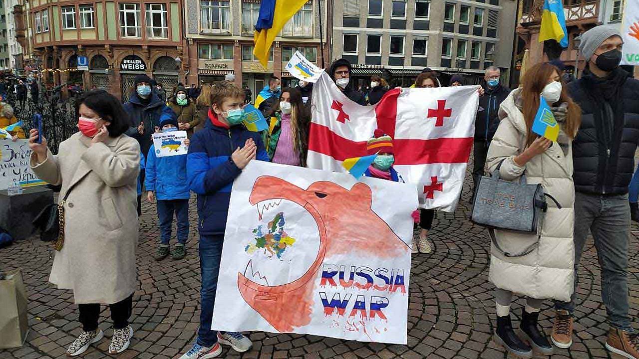 Auf der Demo fordern die Menschen ein Ende von Putins "Militae​raufmarsch" und die Lieferung von Verteidigungswaffen durch befreundete Staaten.