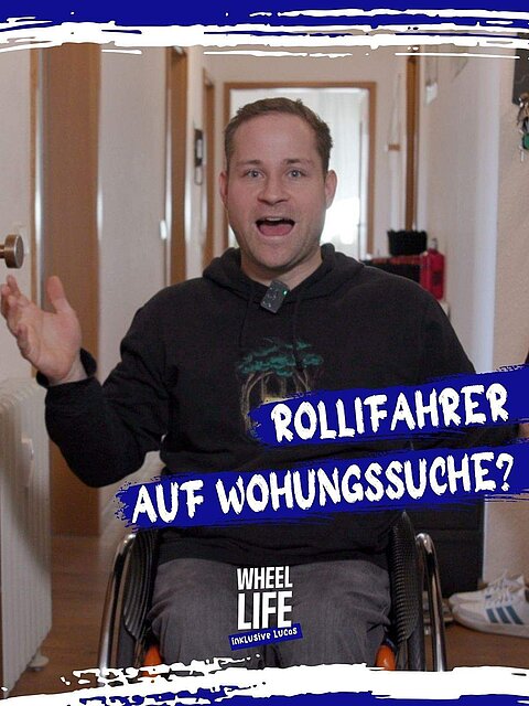 Person im Rollstuhl in einem Flur, die Arme ausgebreitet. Er trägt einen schwarzen Pulli mit grüner Aufschrift. Text: Rollifahrer auf Wohnungssuche?