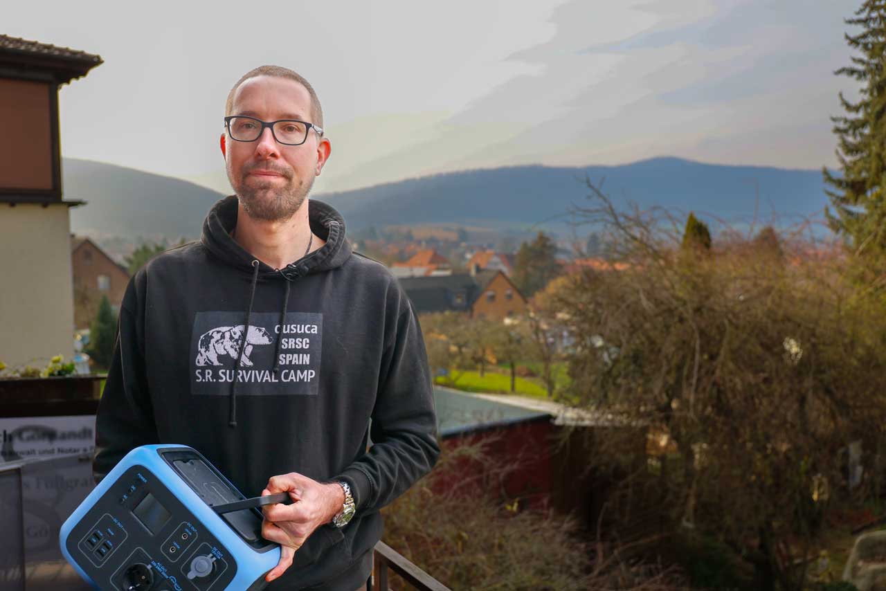 Marius hält einen kleinen Stromgenerator in Händen.