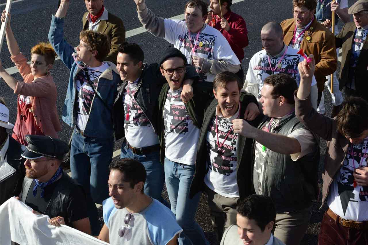 Eine große Gruppe von Demonstrierenden mit bedruckten T-Shirts und Bannern.