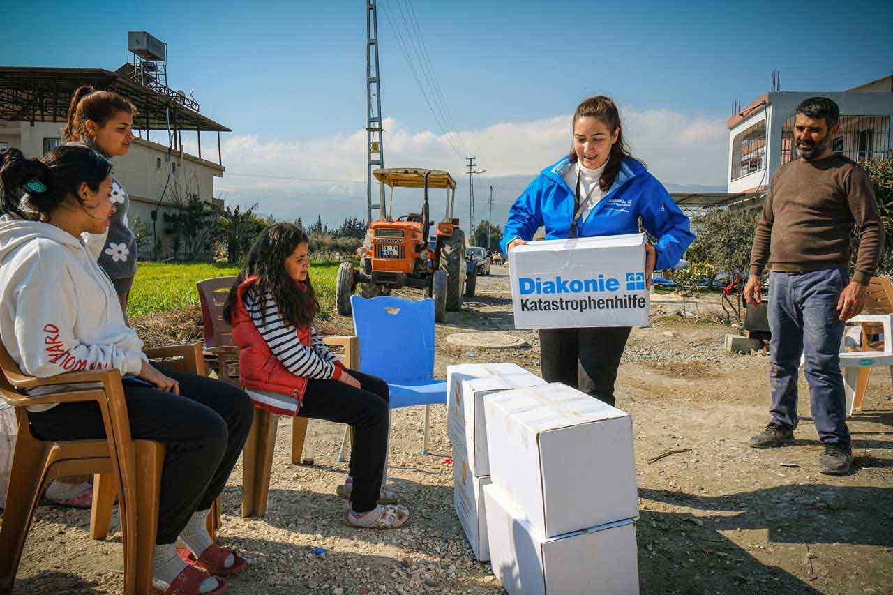 Bilge Menekşe von der Diakonie Katastrophenhilfe übergibt Hygieneboxen 